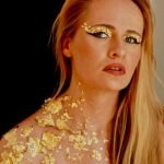 picture of female artist Isolde Schoombie wearing gold makeup